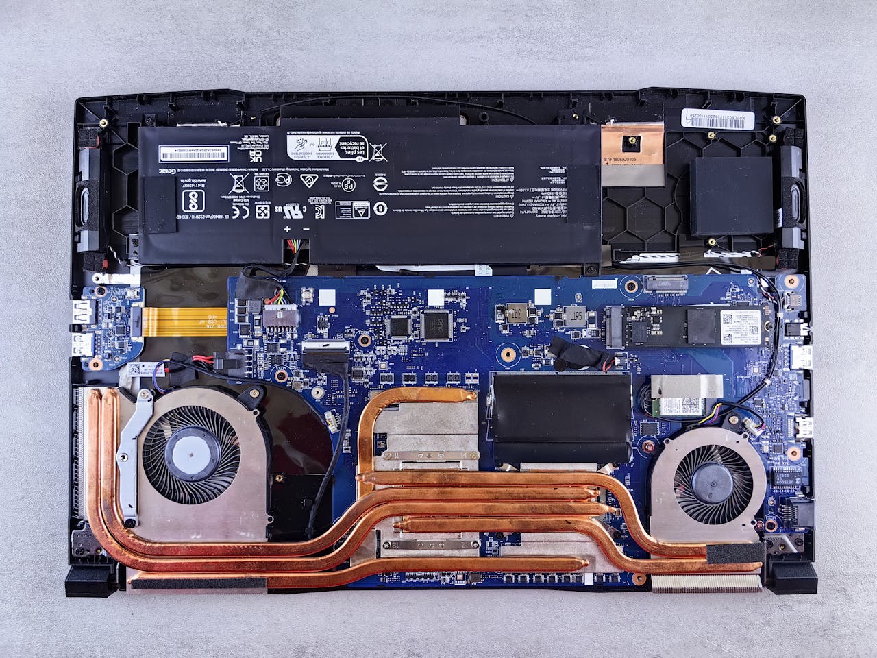Detailed view of laptop motherboard and cooling system components.